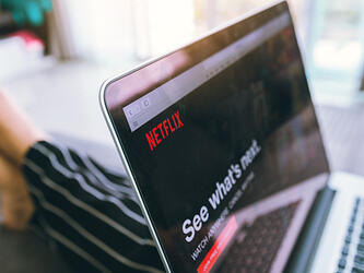 someone watching netflix on laptop